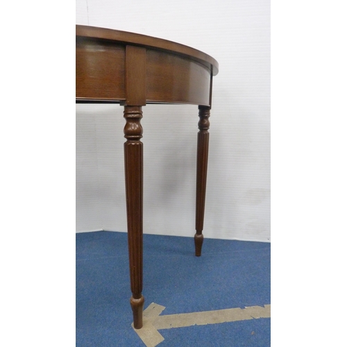 334 - Demi-lune table on fluted supports.