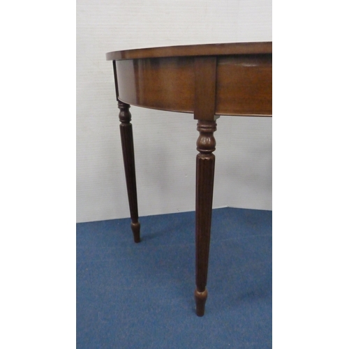 334 - Demi-lune table on fluted supports.