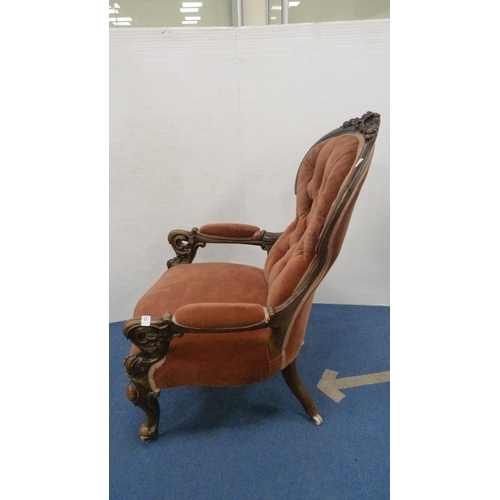 335 - Victorian button-back armchair with pink upholstery, on castors.