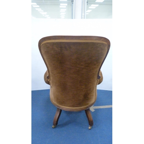 336 - Victorian button-back armchair with brown upholstery, on brass castors.