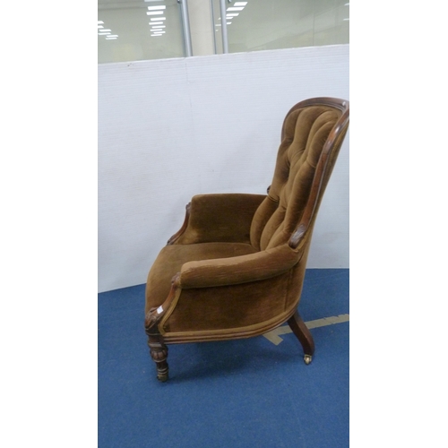 336 - Victorian button-back armchair with brown upholstery, on brass castors.