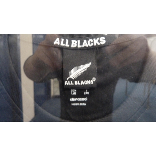 35 - Framed All Blacks rugby training shirt, signed by Sir Graham Henry.