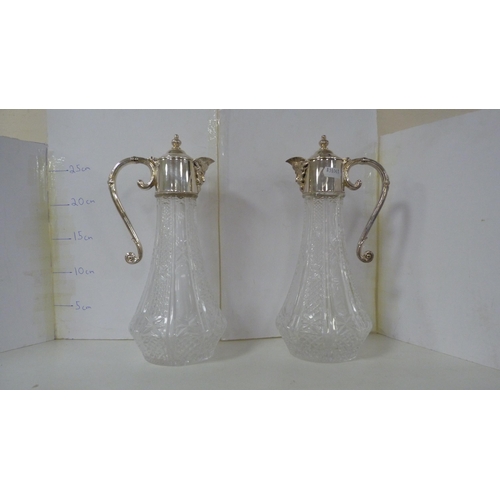 59 - Collection of glassware to include a pair of EP-mounted ewers, decanters, drinking glasses etc (one ... 