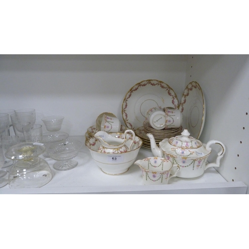 63 - Edwardian floral decorated part tea set and various glassware etc (one shelf).