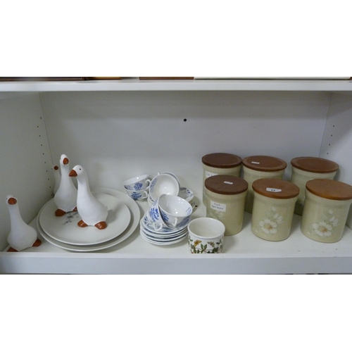 84 - Six Denby storage jars, blue decorated part tea set, four graduated ducks etc (one shelf).