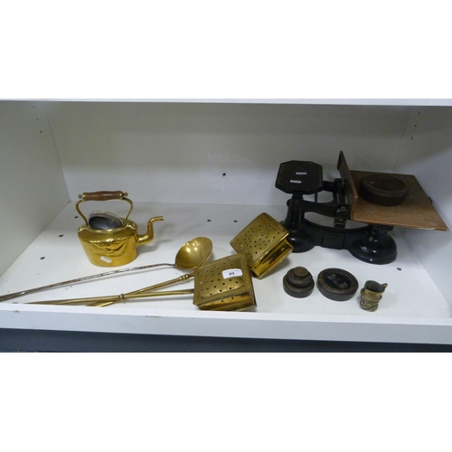 89 - Collection of brassware to include two chestnut warmers, kettle and a set of cast metal scales and w... 