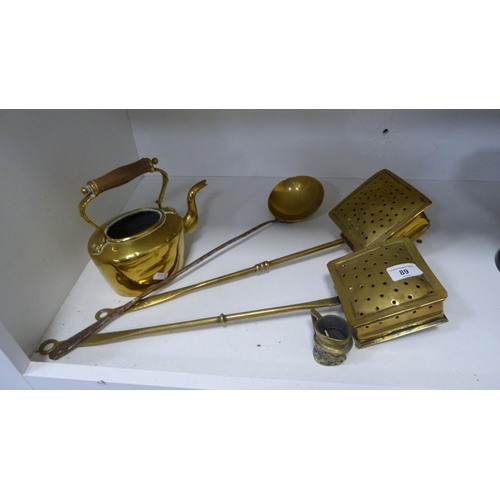 89 - Collection of brassware to include two chestnut warmers, kettle and a set of cast metal scales and w... 