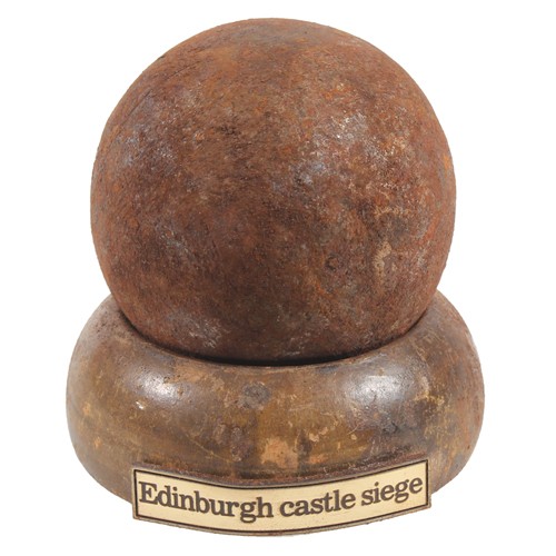 Cast iron cannonball on stand with Edinburgh Castle Siege banner.