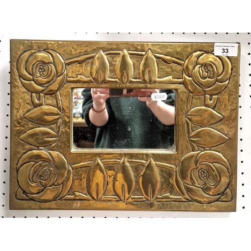 33 - Arts and Crafts style rectangular brass bound mirror with stylised roses. 28cm x 38cm