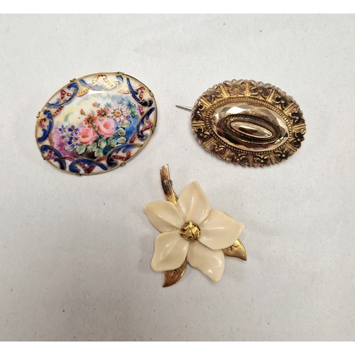 55 - 10ct gold floral carved plastic/bone brooch, a yellow metal mourning brooch (5.3g), and another with... 