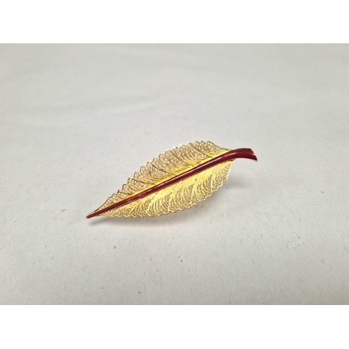 62 - Gold filigree brooch with red enamel detail in the form of a leaf, the pin marked indistinctly possi... 