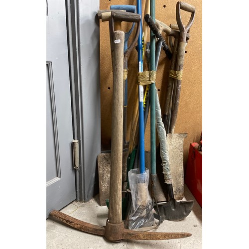 734 - Assorted hand-tools, forks spades shovels pick axe etc