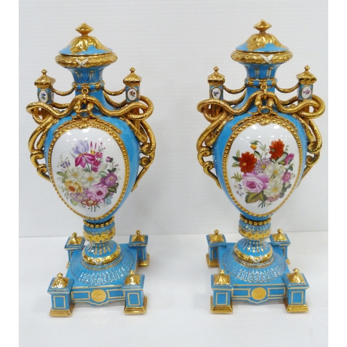256 - Pair of large porcelain vases and covers decorated with cartouches of flowers and gilded coiled snak... 
