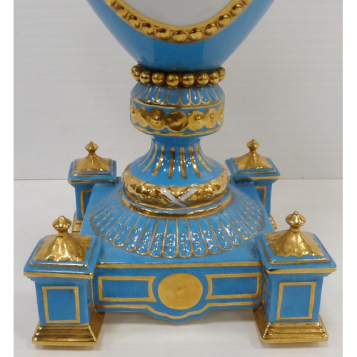 256 - Pair of large porcelain vases and covers decorated with cartouches of flowers and gilded coiled snak... 