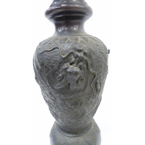 308 - Pair of Japanese cast metal vases of baluster form, Meiji 1868 - 1912, on tripod table supports and ... 