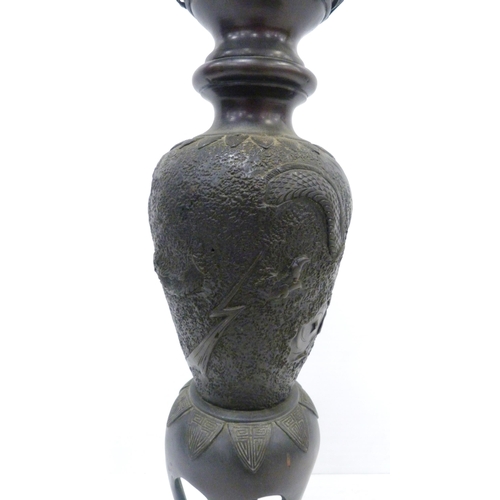 308 - Pair of Japanese cast metal vases of baluster form, Meiji 1868 - 1912, on tripod table supports and ... 