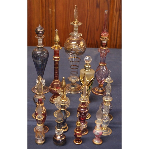 12 - Seventeen Eastern glass perfume bottles, the largest 24cm high.