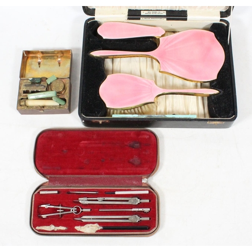 43 - 1930s pink guilloche enamel dressing set, a wax seal set and a compass set.