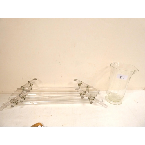 211 - Glass plate stand and glass measuring jug.