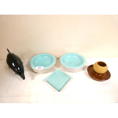 217 - Four pieces of Poole pottery to include dolphin, two bowls, dish etc.