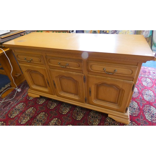 283 - Modern oak three door over three drawer sideboard.