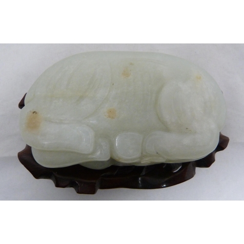 315 - Chinese celadon jade carving of a recumbent kylin, Qing Dynasty, on a padouk stand, 9cm, and another... 