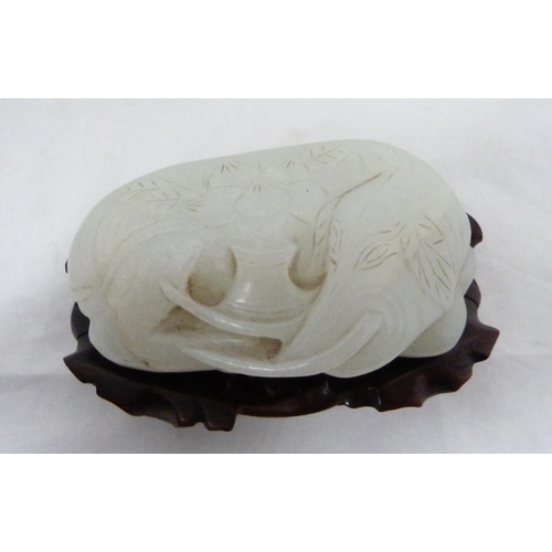 315 - Chinese celadon jade carving of a recumbent kylin, Qing Dynasty, on a padouk stand, 9cm, and another... 