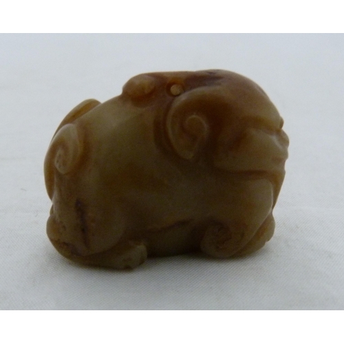 315 - Chinese celadon jade carving of a recumbent kylin, Qing Dynasty, on a padouk stand, 9cm, and another... 