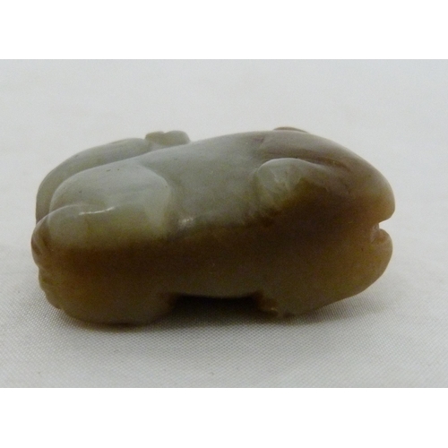 315 - Chinese celadon jade carving of a recumbent kylin, Qing Dynasty, on a padouk stand, 9cm, and another... 