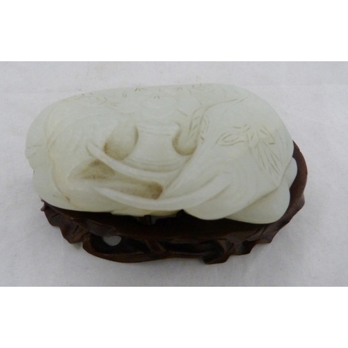 315 - Chinese celadon jade carving of a recumbent kylin, Qing Dynasty, on a padouk stand, 9cm, and another... 