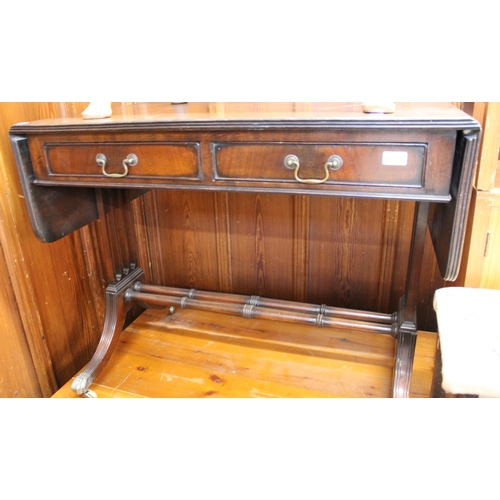 600 - Mahogany drop leaf sofa table with lyre ends, raised on brass castors, 93cm wide x 76cm tall.