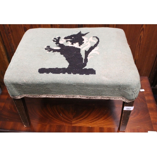 602 - Mahogany footstool upholstered in green with lion rampant.