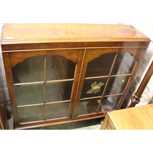 657 - Mahogany two door glazed display cabinet raised on cabriole supports.