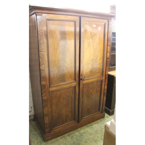 666 - Flame cut Victorian mahogany two door wardrobe om plinth base, 126cm wide x 189cm tall.