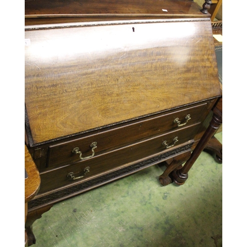 671 - Mahogany two drawer bureau raised on ball and claw feet.