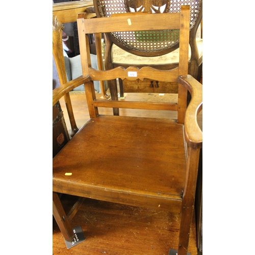 672 - Victorian mahogany open armchair with wooden seat. 