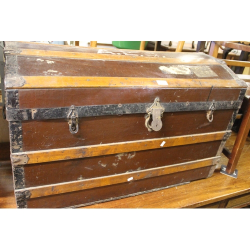 673 - Wood and metal bound domed top trunk, 90cm wide.