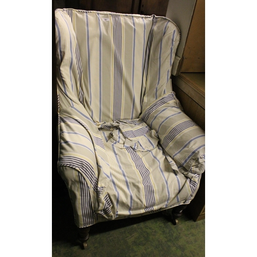 691 - Antique mahogany upholstered wing armchair.