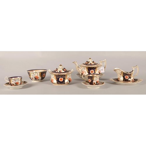 19 - Imari pattern tea set with hand-painted flower decoration, to include teapot, teacups sugar bowl etc