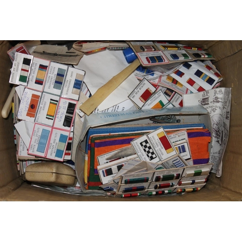 321 - Two boxes containing medal ribbon bars, scouting stickers, postcards, etc.