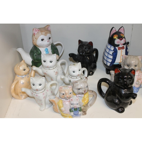 324 - Shelf containing novelty cat models and cat teapots, etc.