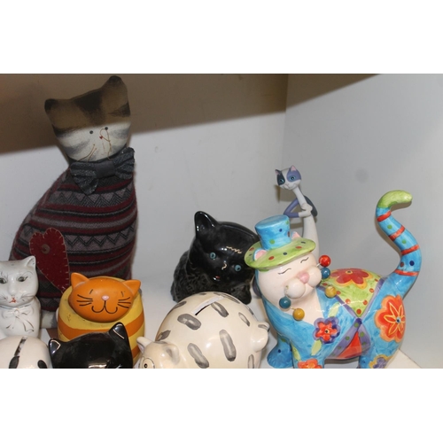 324 - Shelf containing novelty cat models and cat teapots, etc.