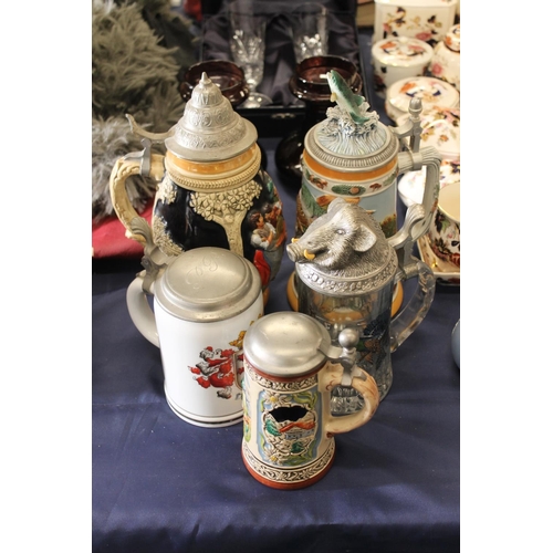 85 - Five German steins to include a Gerz stein decorated with fish, a glass stein with game bird and ani... 