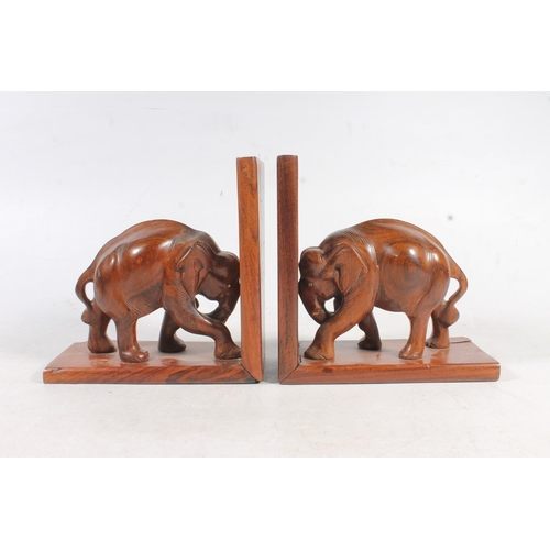 89 - Pair of carved wooden elephant bookends, a Chinese style horse model, and a Folk Art carved wooden f... 