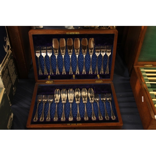 94 - Two canteens of silver-plated cutlery.