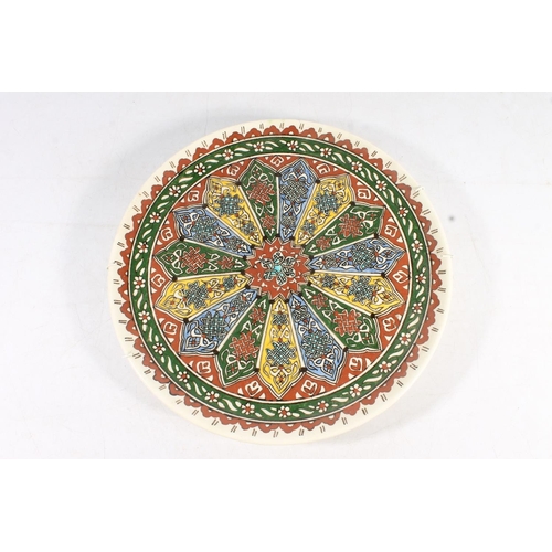 96 - Continental pottery charger decorated with Nordic style knotwork in polychrome colours, 32cm wide.