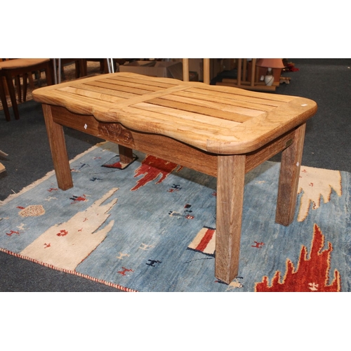 588 - Oak coffee table raised on square supports, 110cm wide x 48cm tall.