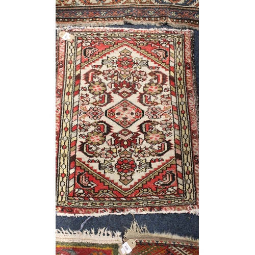 697 - Cream and red ground rug with floral field and multi border, 82cm x 62cm.