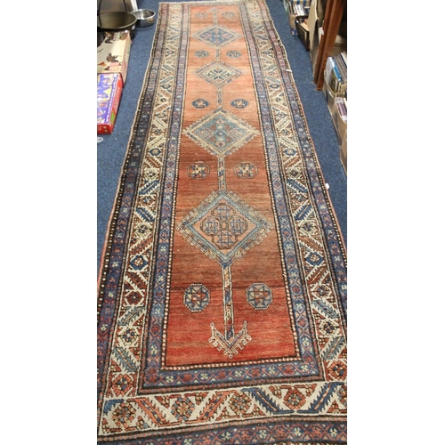 698 - Red ground multi bordered hall runner, 370cm x 100cm.