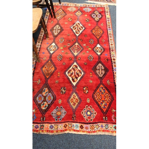 701 - Red ground rug with geometric pattern, 210cm x 105cm.